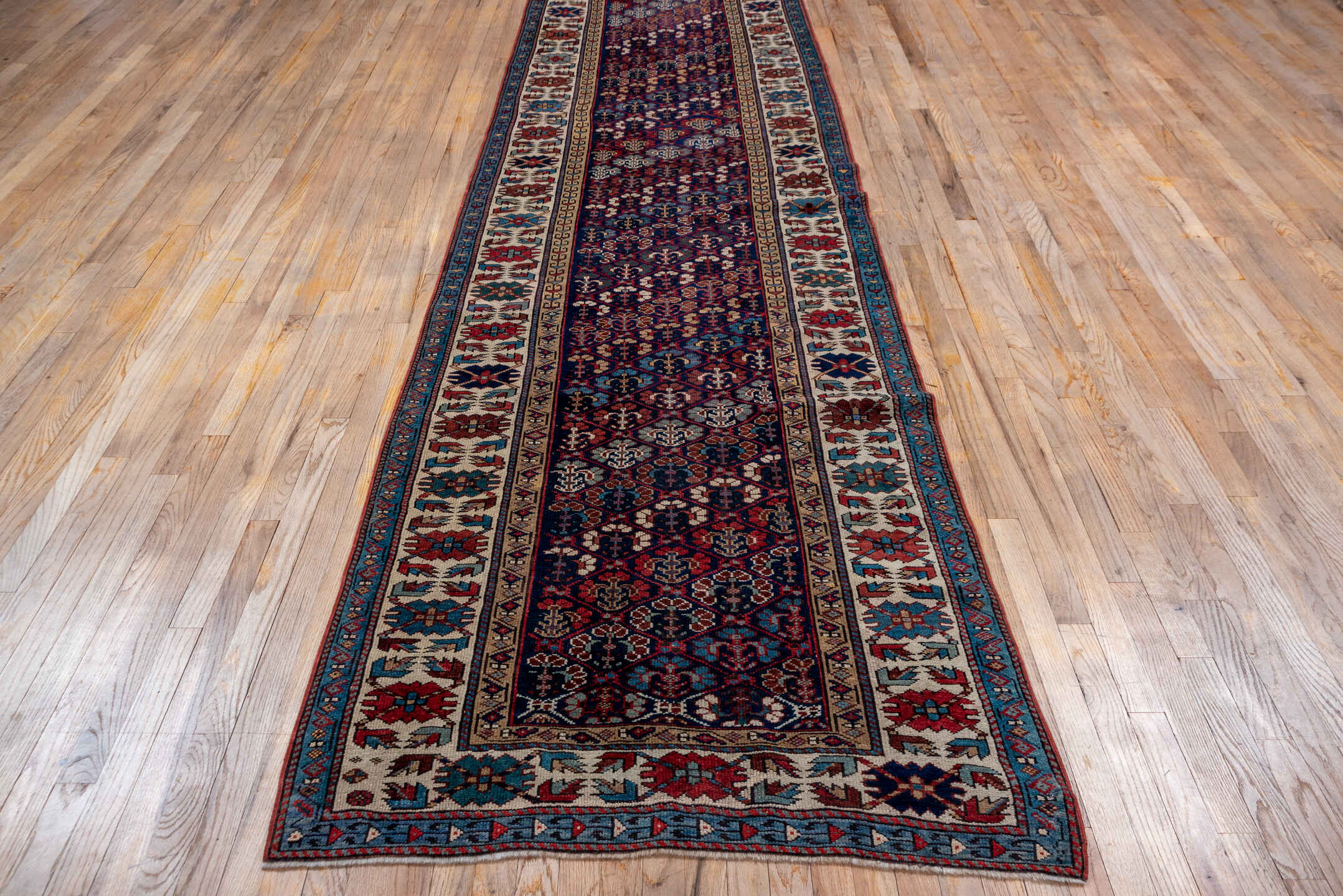 3' x 12' one-of-a-kind handmade antique NW Persian runner rug. Color palette: indigo, ivory, rust, sky blue, crimson, navy