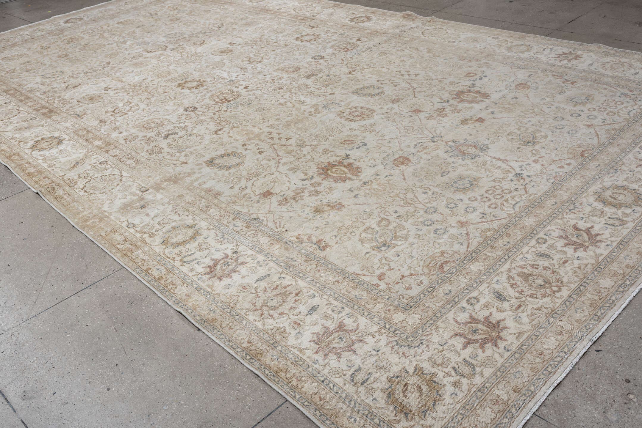 9' x 18' one-of-a-kind handmade antique Tabriz rug. Color palette: ivory, taupe, beige, camel, pale blue, sage, soft gold