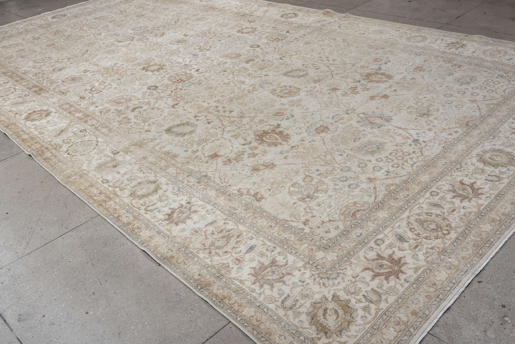 9' x 18' one-of-a-kind handmade antique Tabriz rug. Color palette: ivory, taupe, beige, camel, pale blue, sage, soft gold