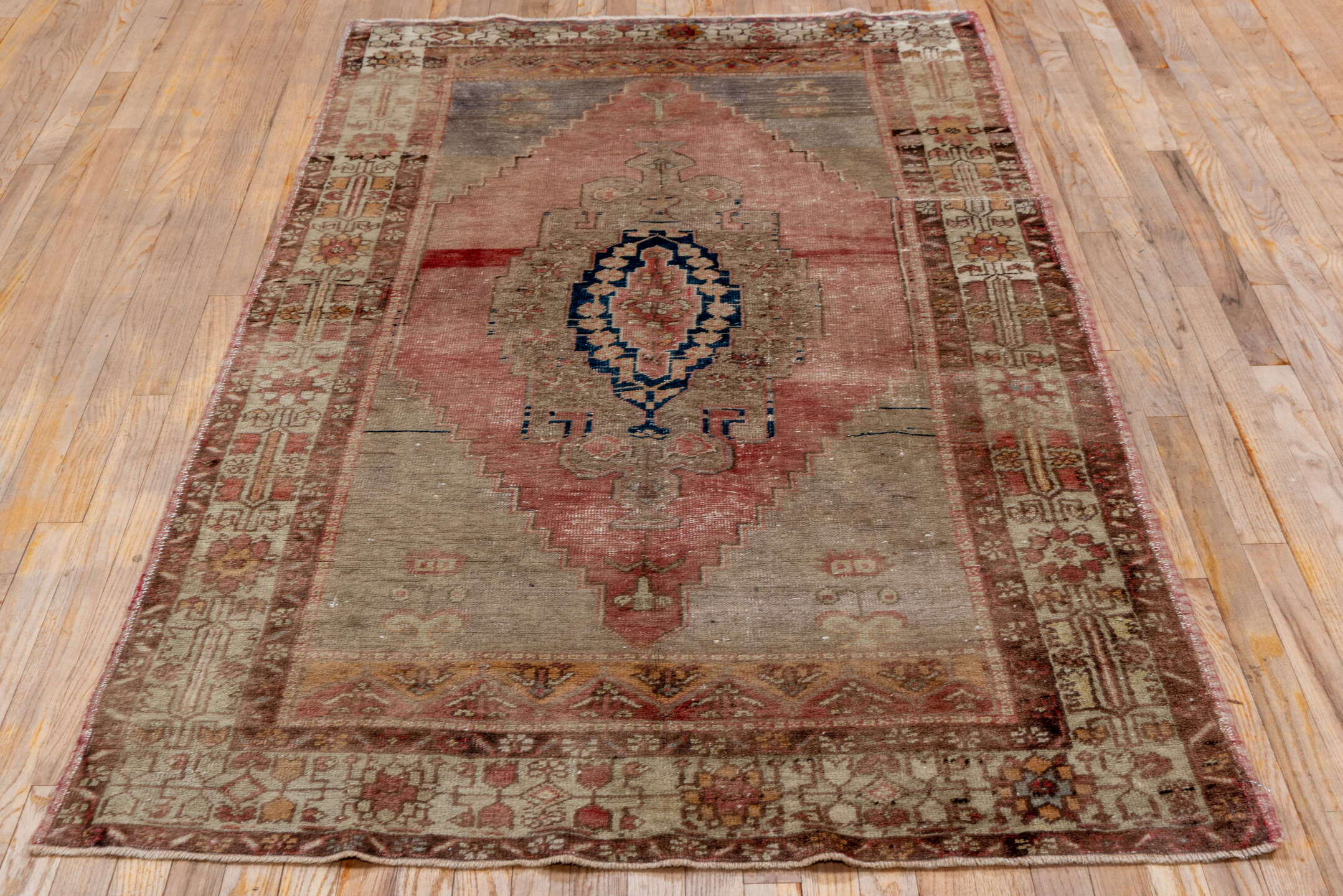 4' x 7' one-of-a-kind handmade vintage Oushak rug. Color palette: rose, ivory, taupe, dusty blue, indigo, terra cotta