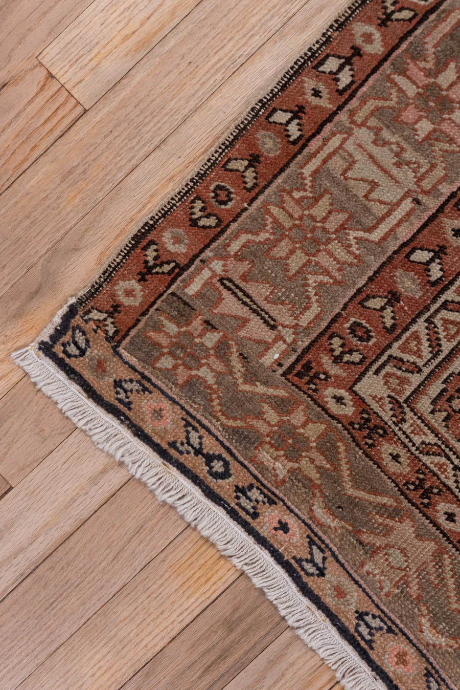 4' x 5' one-of-a-kind handmade antique Serapi small size rug. Color palette: terra cotta, taupe, brown, ivory, camel, slate