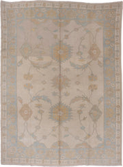 9' x 12' one-of-a-kind handmade vintage Oushak large size rug. Color palette: ivory, pale blue, taupe, gold, beige, sage