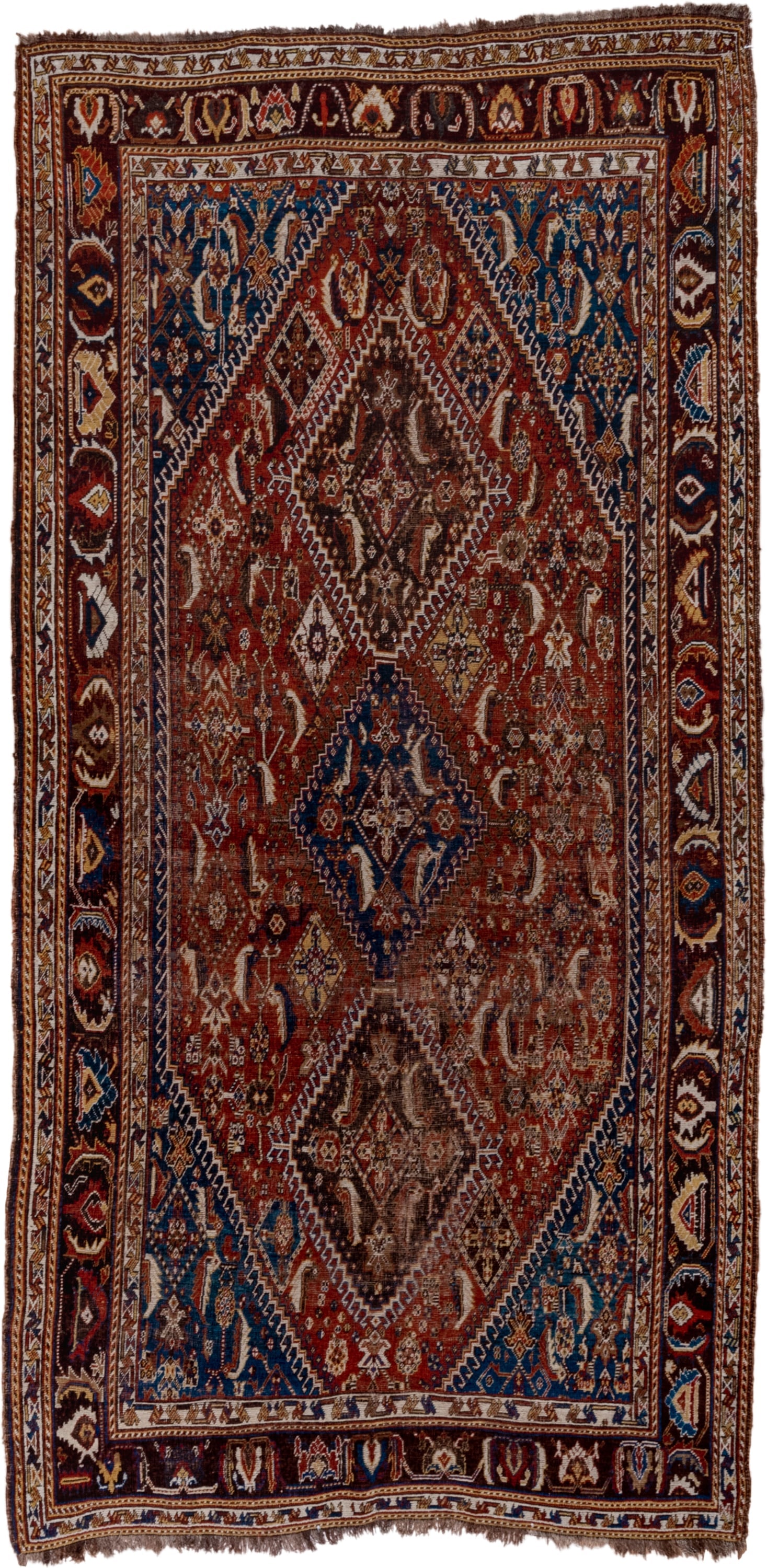5' x 9' one-of-a-kind handmade antique Qashqai medium size rug. Color palette: rust, indigo, ivory, walnut, camel, navy