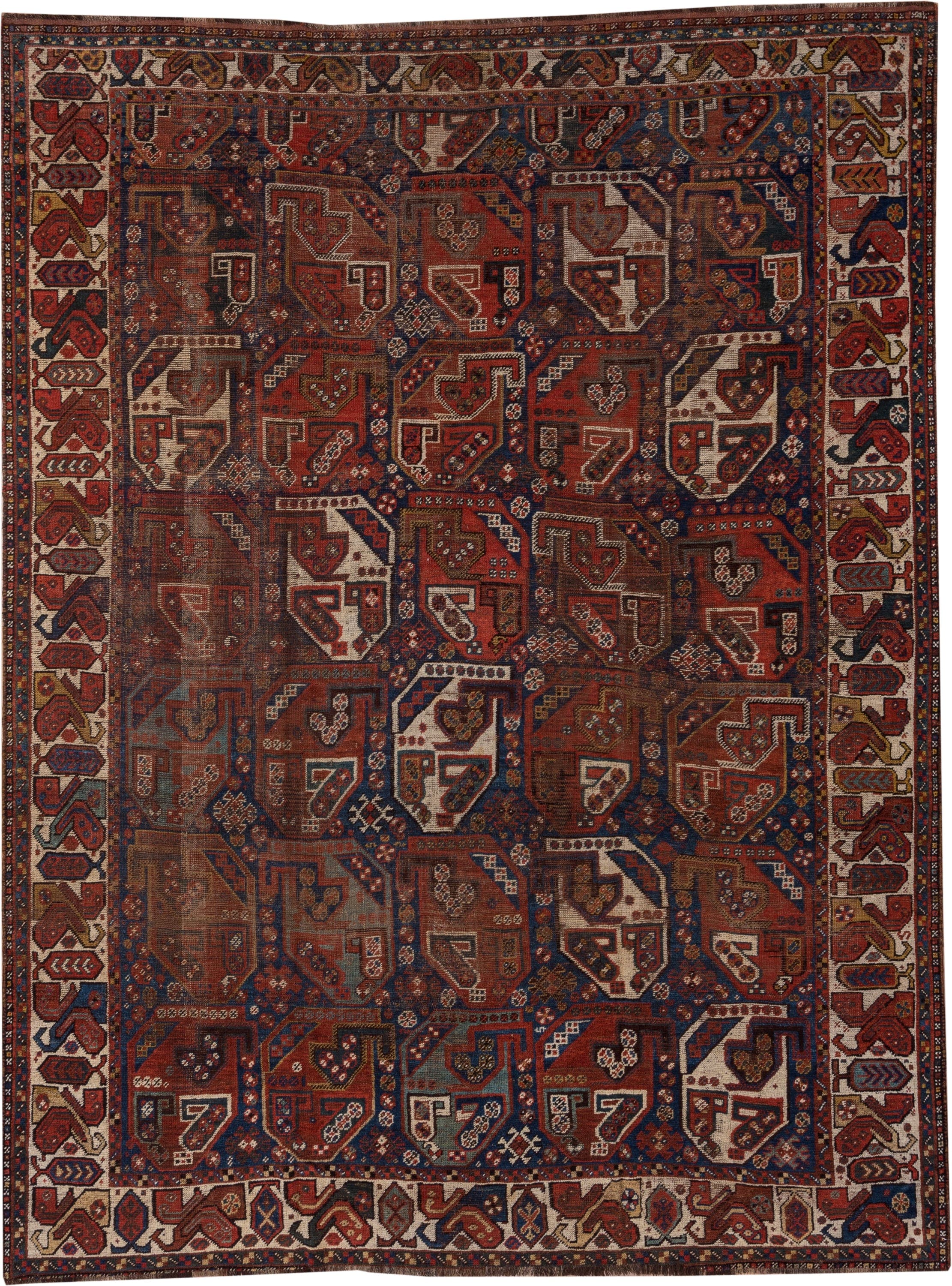 7' x 9' one-of-a-kind handmade antique Shiraz rug. Color palette: rust, indigo, ivory, brick, camel, navy, brown, terracotta