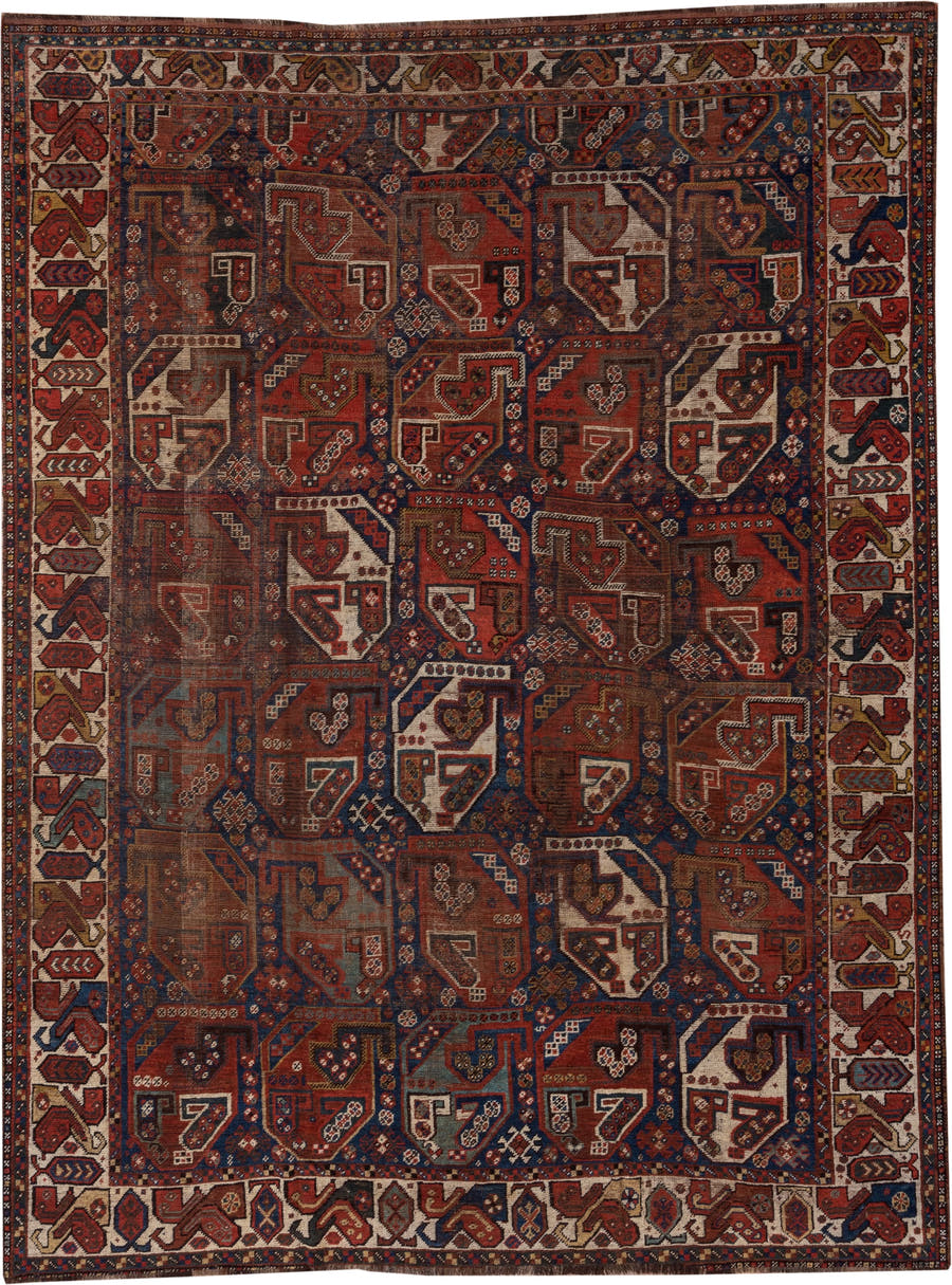 7' x 9' one-of-a-kind handmade antique Shiraz rug. Color palette: rust, indigo, ivory, brick, camel, navy, brown, terracotta
