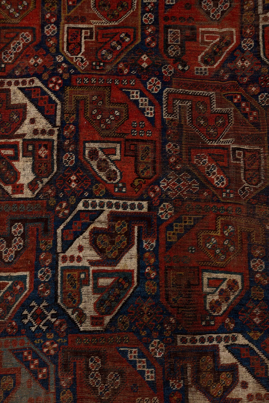 7' x 9' one-of-a-kind handmade antique Shiraz rug. Color palette: rust, indigo, ivory, brick, camel, navy, brown, terracotta