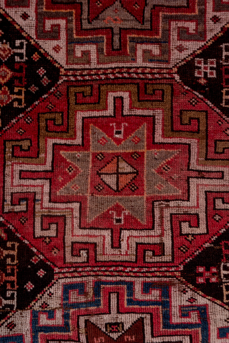 4' x 9' one-of-a-kind handmade vintage Kazak runner rug. Color palette: brown, gray, pink, red, rosy brown