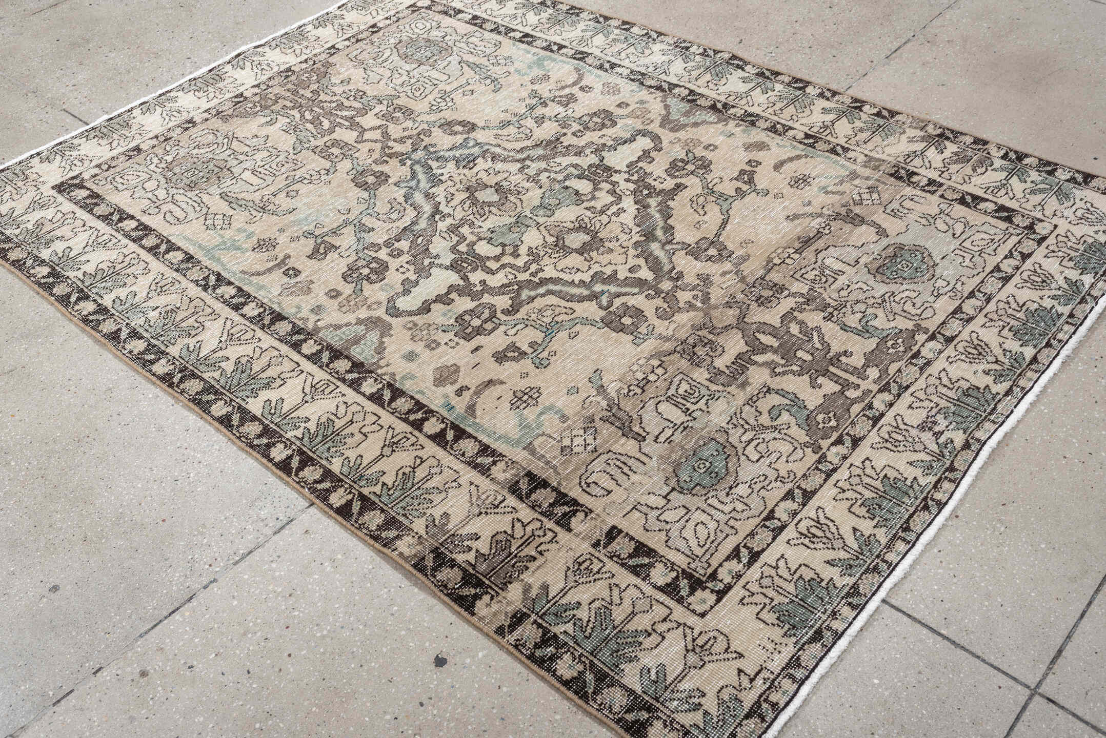 5' x 6' one-of-a-kind handmade vintage Baktiary rug. Color palette: ivory, charcoal, taupe, pale aqua, sage, beige, black