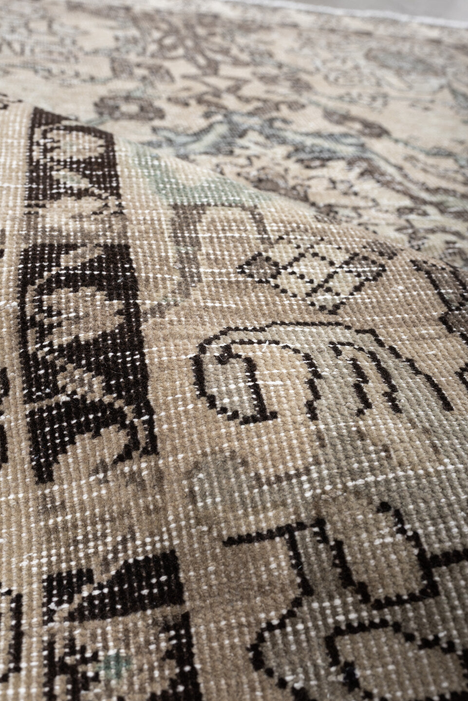 5' x 6' one-of-a-kind handmade vintage Baktiary rug. Color palette: ivory, charcoal, taupe, pale aqua, sage, beige, black