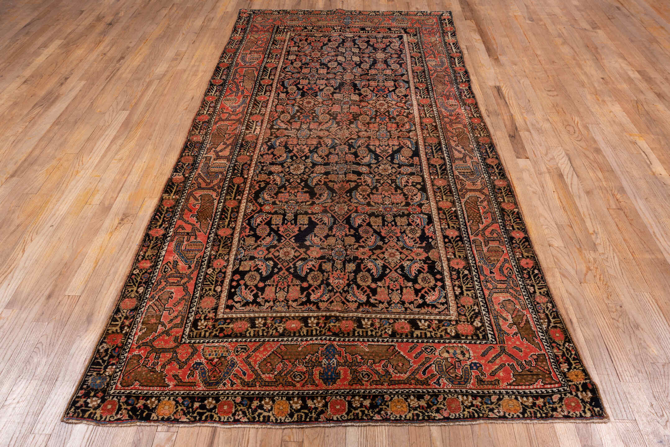 4' x 10' one-of-a-kind handmade vintage Malayer runner rug. Color palette: black, blue, brown, charcoal, gray, pink, red