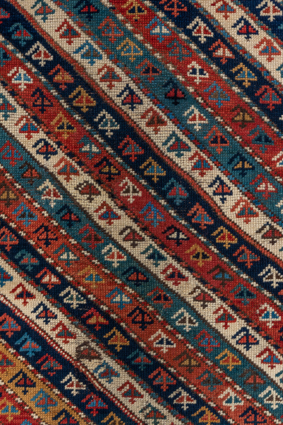 4' x 9' one-of-a-kind handmade antique Kazak runner rug. Color palette: rust, ivory, blue, navy, camel, crimson, charcoal
