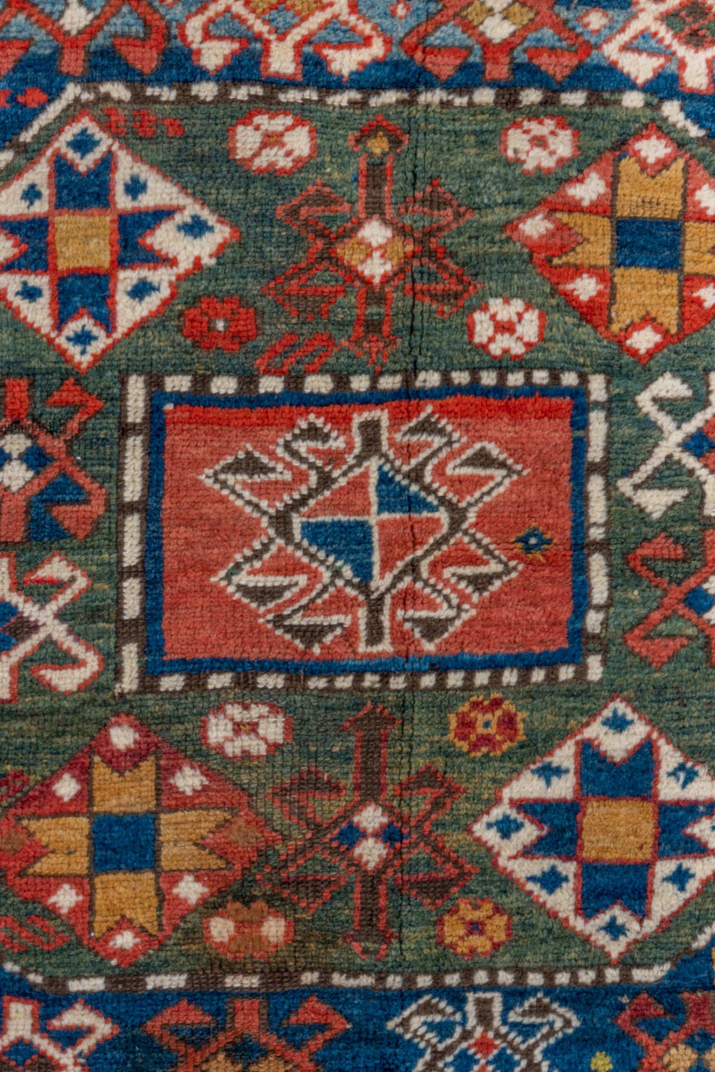 4' x 6' one-of-a-kind handmade vintage Kazak small size rug. Color palette: navy, rust, ivory, olive, crimson, camel