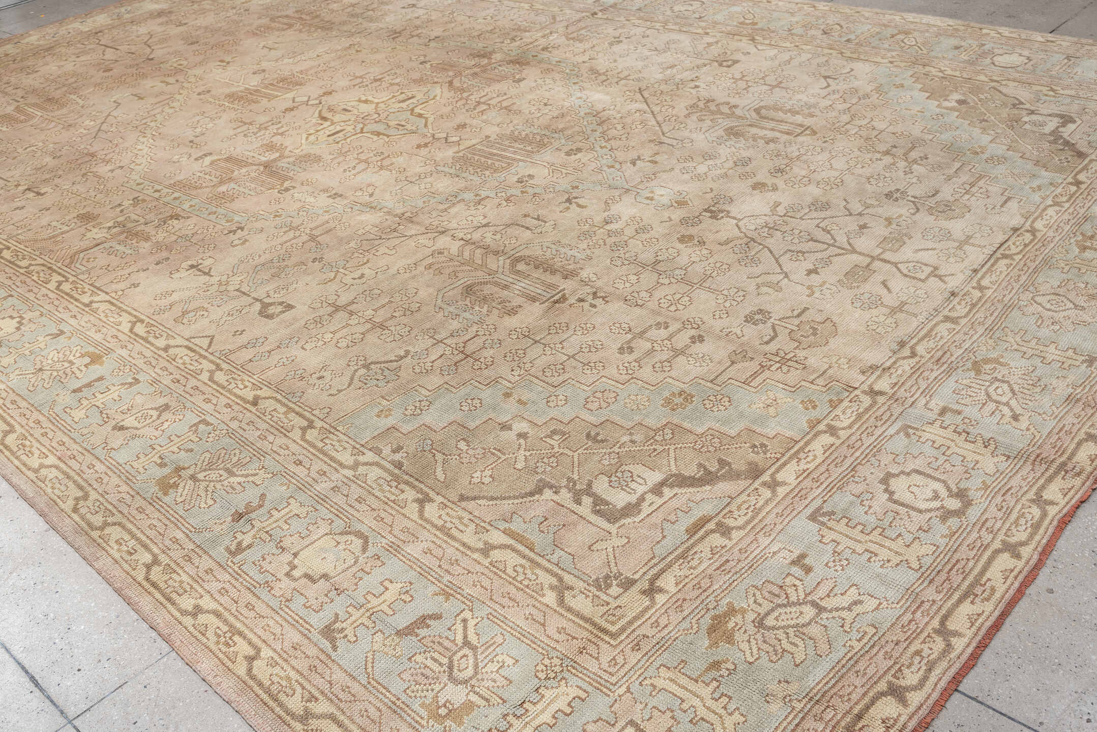 12' x 18' one-of-a-kind handmade antique Oushak oversize rug. Color palette: ivory, taupe, pale blue, faded terracotta