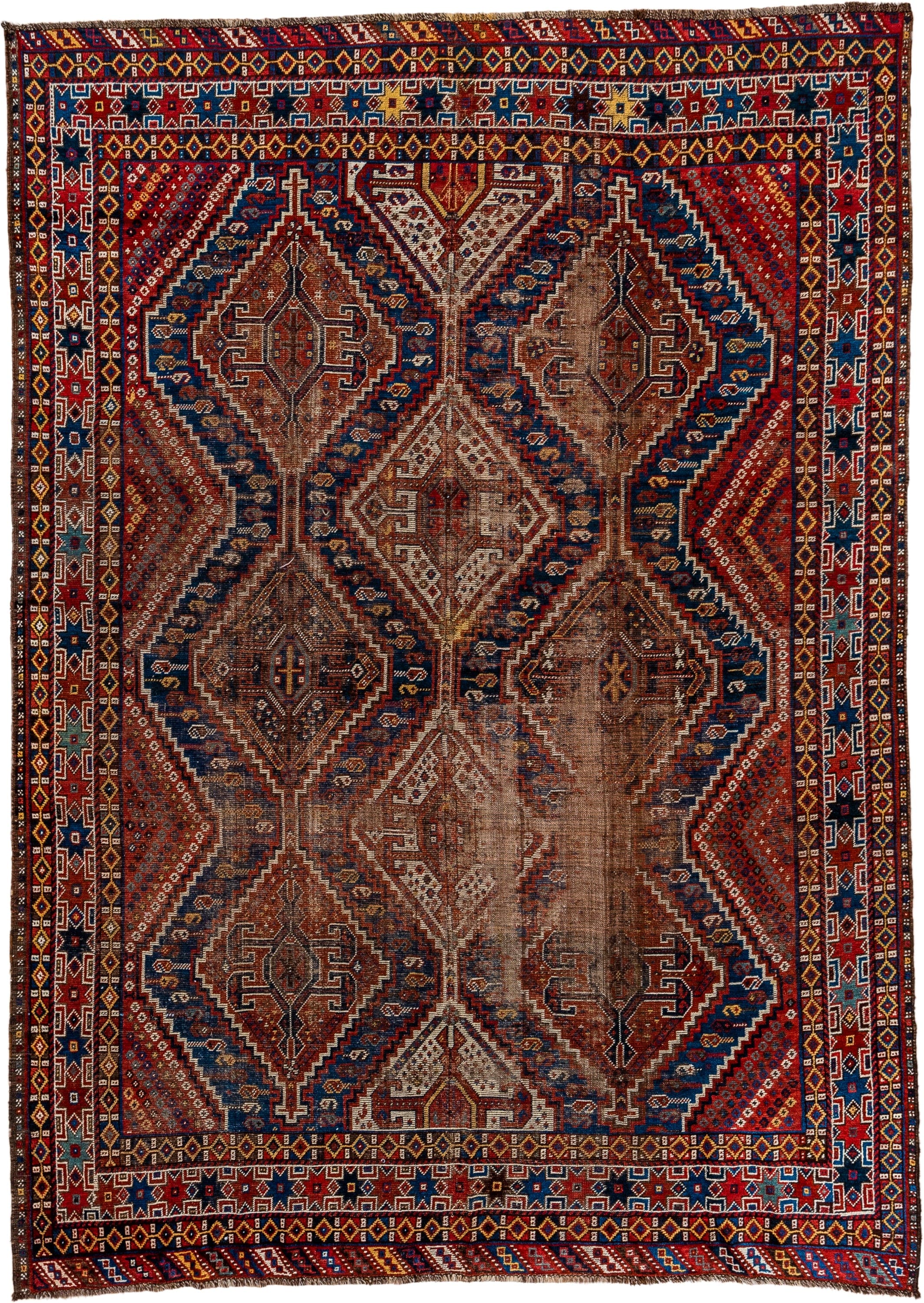 7' x 9' one-of-a-kind handmade vintage Shiraz rug. Color palette: rust, indigo, camel, ivory, crimson, navy, gold, brown