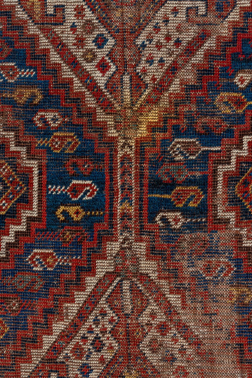 7' x 9' one-of-a-kind handmade vintage Shiraz rug. Color palette: rust, indigo, camel, ivory, crimson, navy, gold, brown