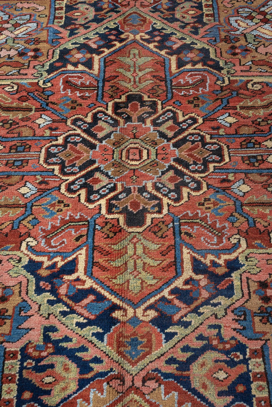 11' x 16' one-of-a-kind handmade antique Heriz oversize rug. Color palette: rust, navy, ivory, turquoise, terracotta, sage