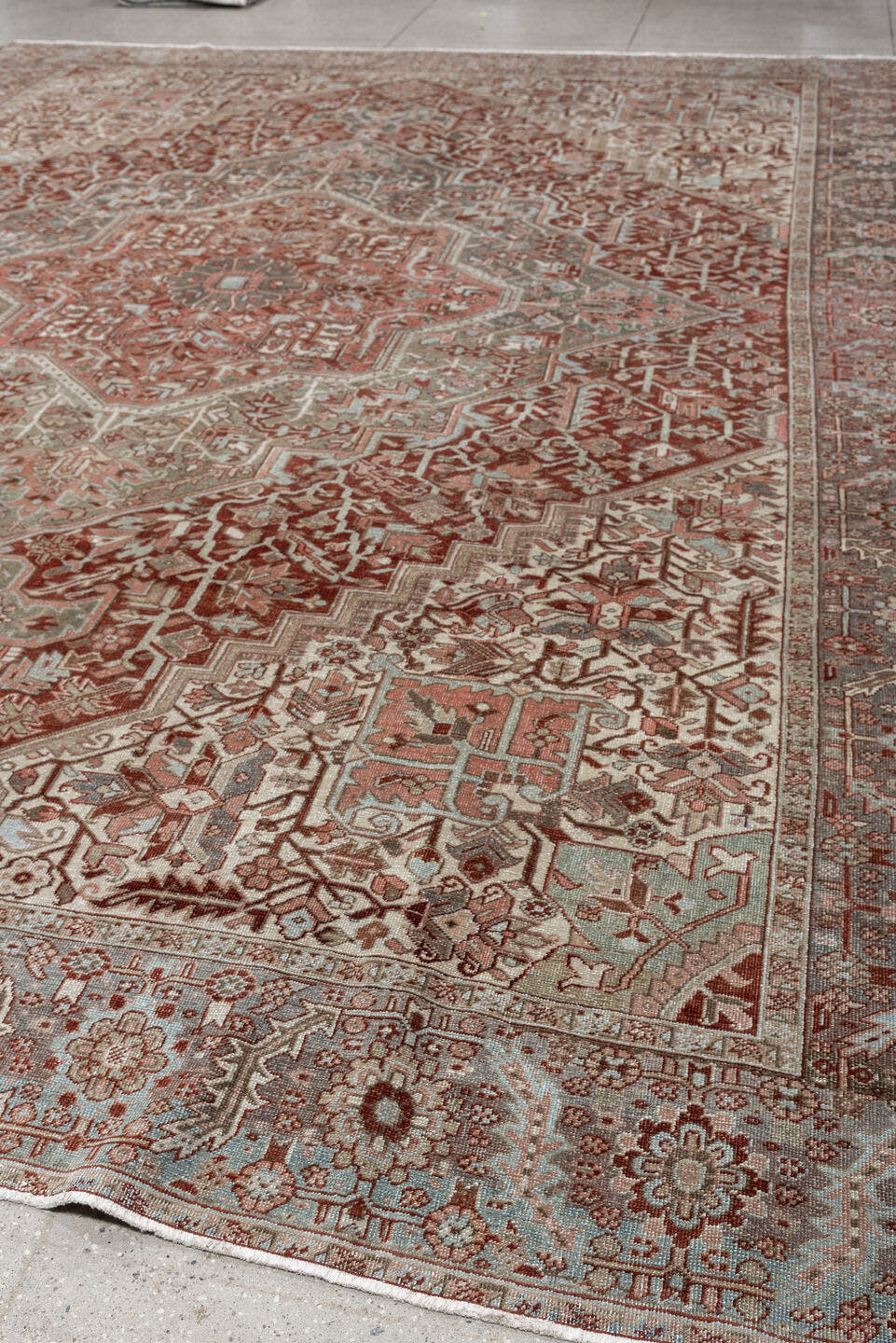 11' x 15' one-of-a-kind handmade antique Heriz oversize rug. Color palette: rust, ivory, sage, slate blue, dusty rose, taupe