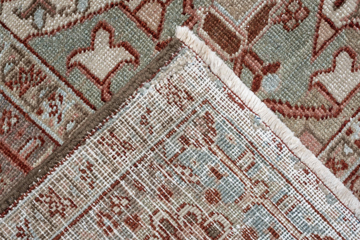 11' x 15' one-of-a-kind handmade antique Heriz oversize rug. Color palette: rust, ivory, sage, slate blue, dusty rose, taupe