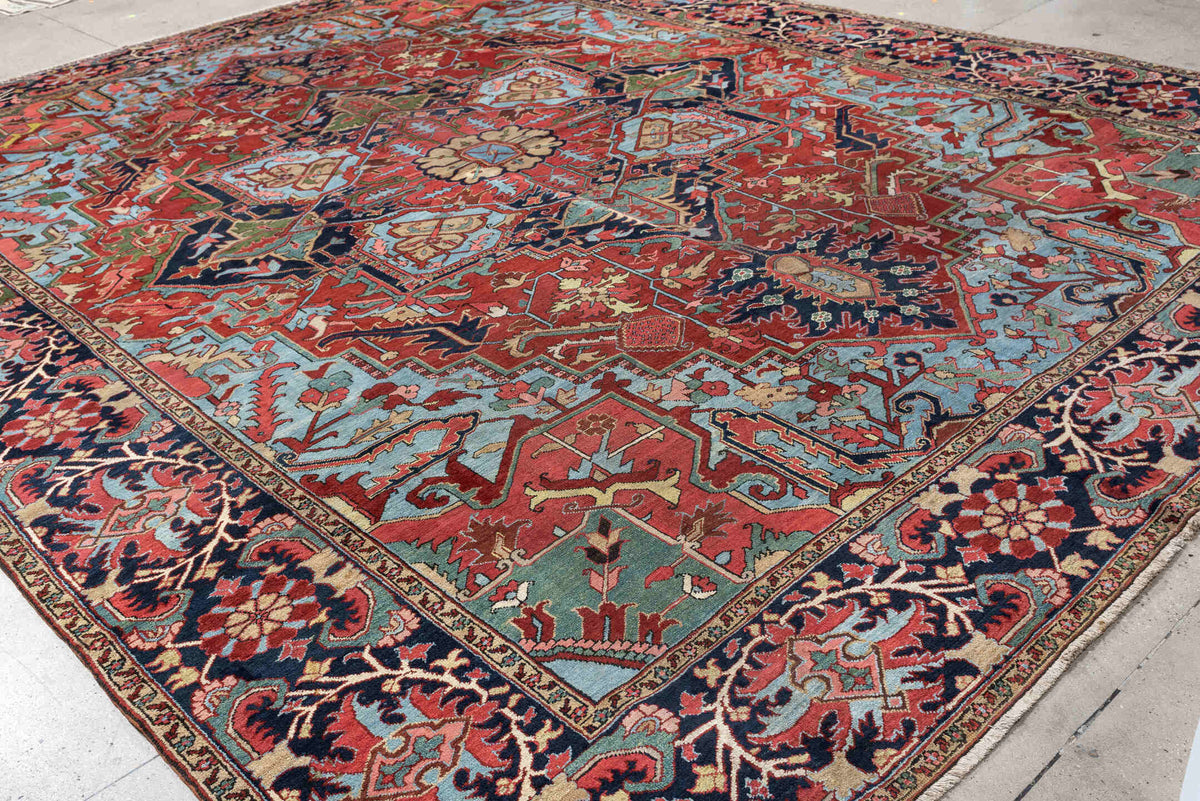12' x 15' one-of-a-kind handmade antique Heriz oversize rug. Color palette: brick red, navy, turquoise, ivory, sage, coral
