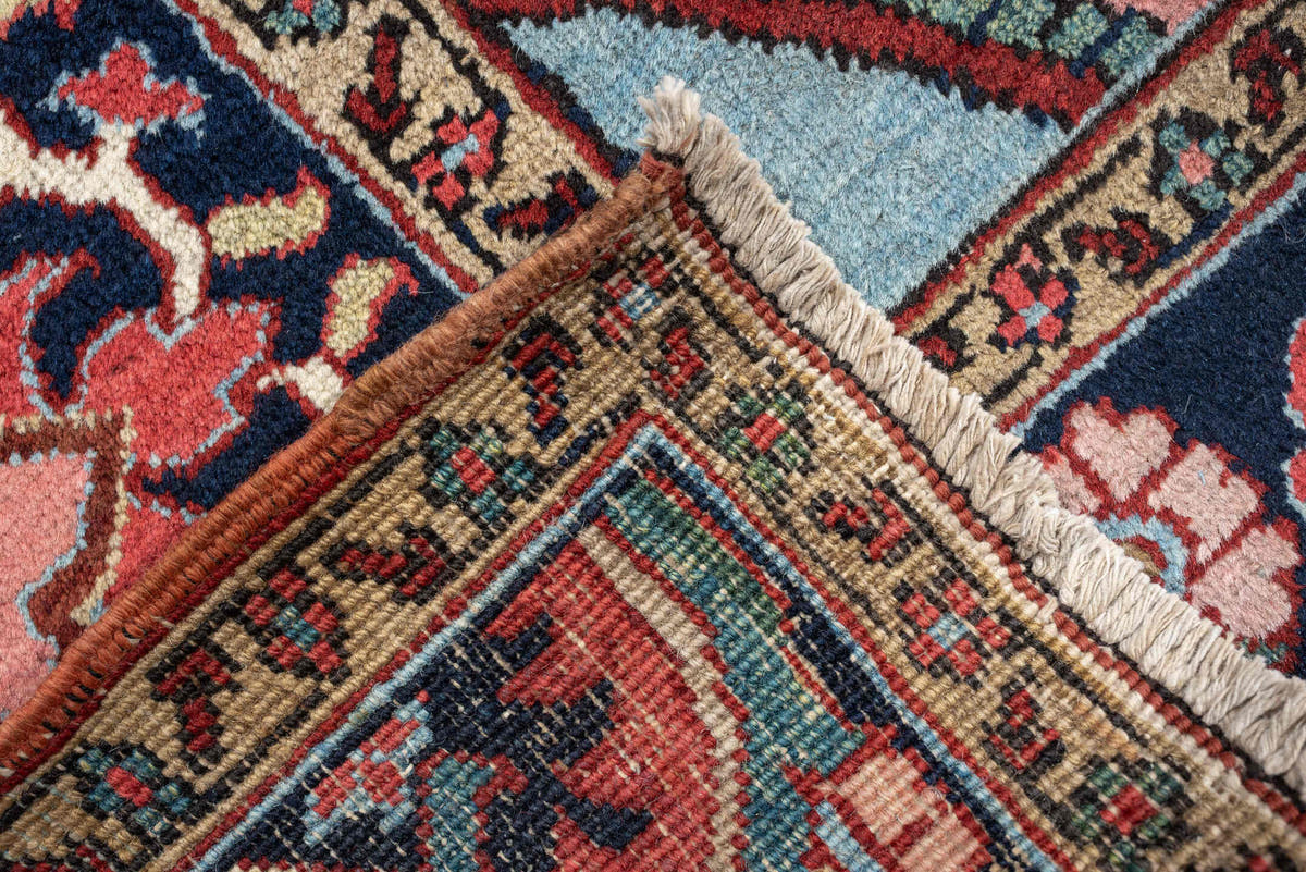 12' x 15' one-of-a-kind handmade antique Heriz oversize rug. Color palette: brick red, navy, turquoise, ivory, sage, coral