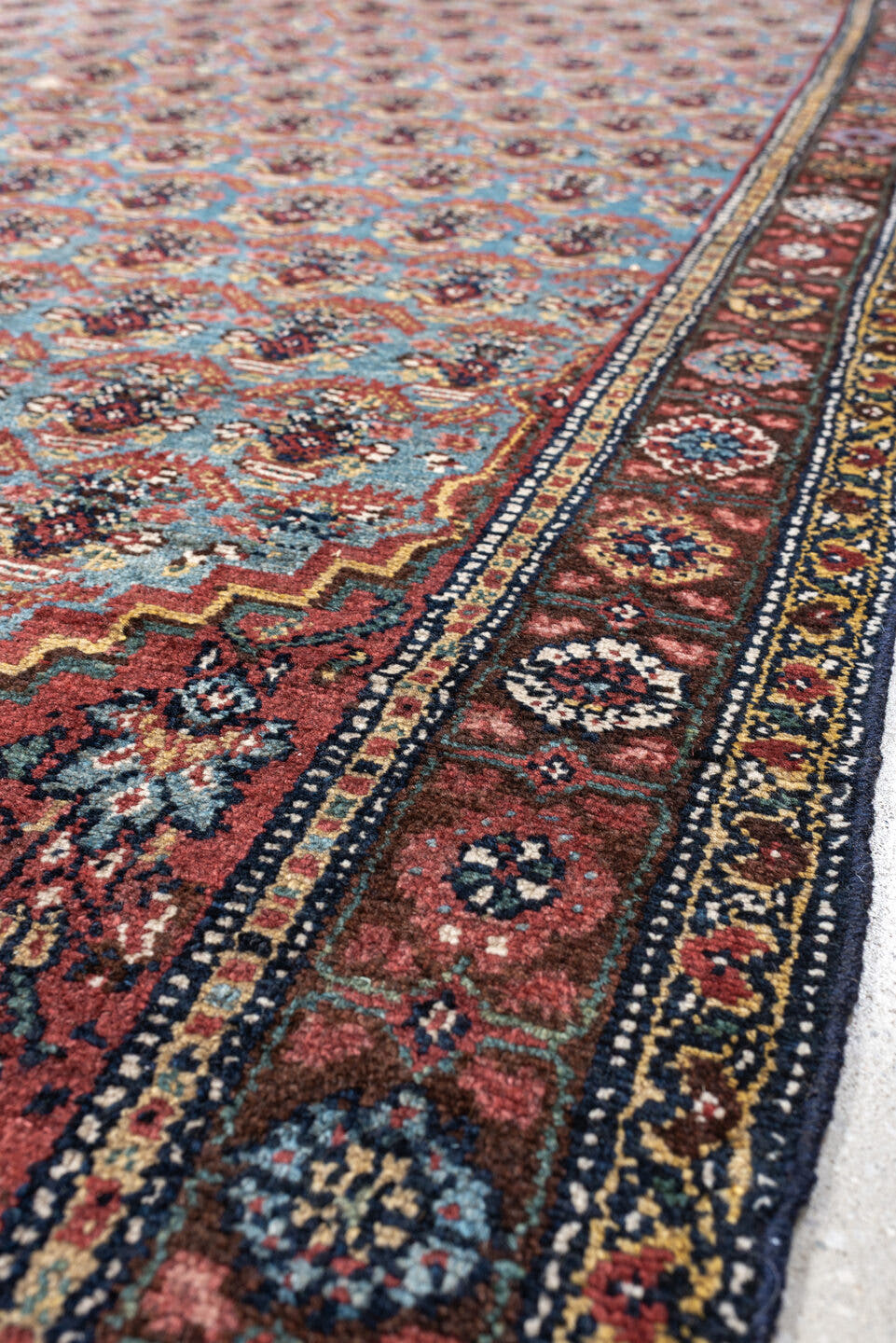 5' x 10' one-of-a-kind handmade antique Malayer rug. Color palette: turquoise, madder red, navy, ivory, saffron, charcoal