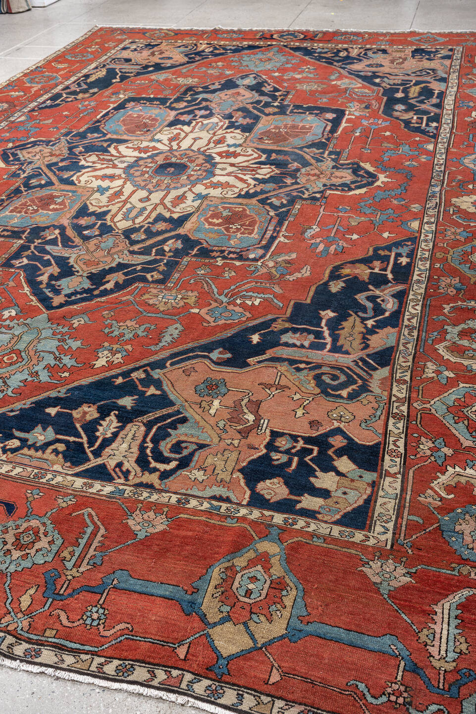 11' x 16' one-of-a-kind handmade antique Serapi oversize rug. Color palette: terracotta, navy, ivory, sky blue, camel, rose