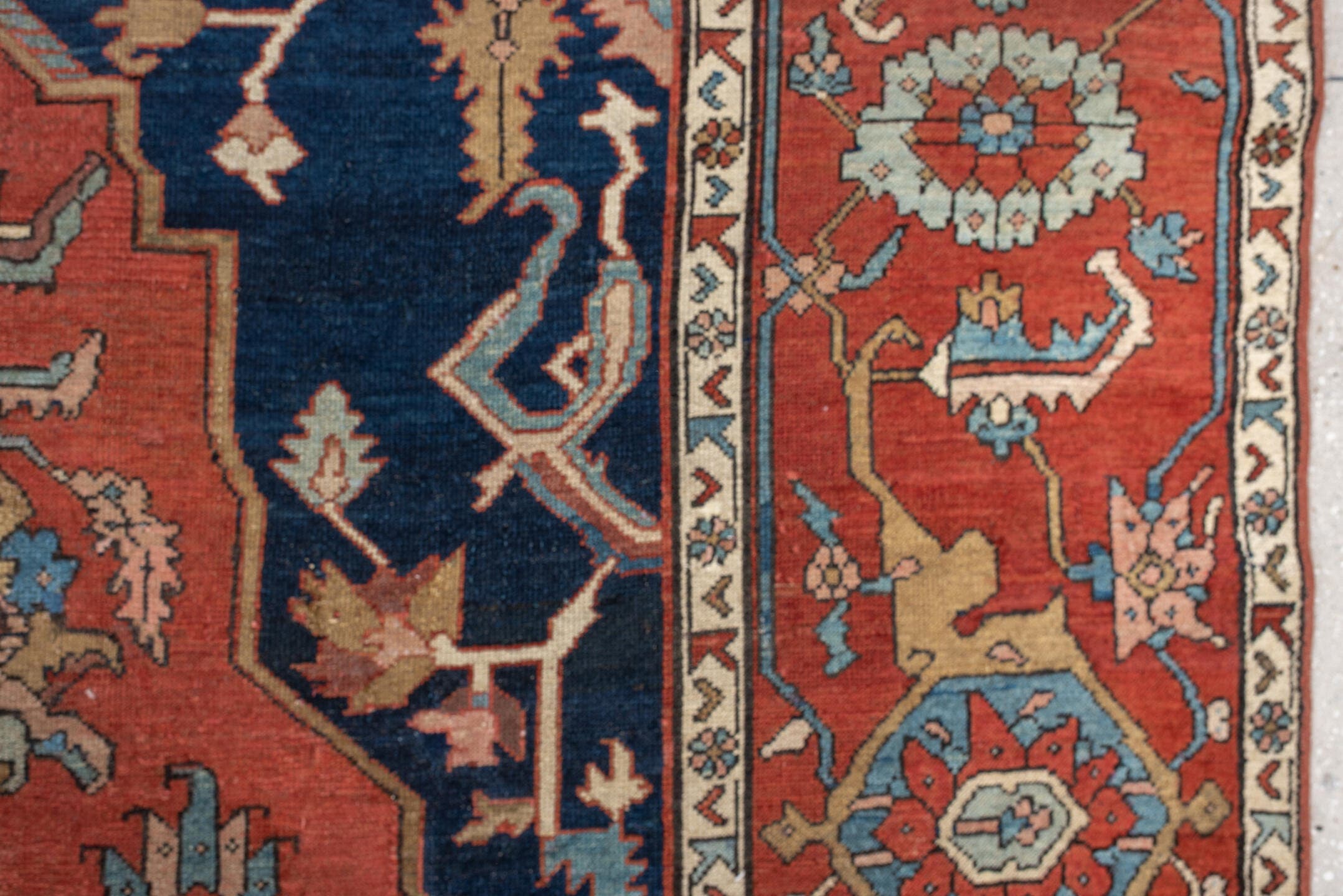 11' x 16' one-of-a-kind handmade antique Serapi oversize rug. Color palette: terracotta, navy, ivory, sky blue, camel, rose