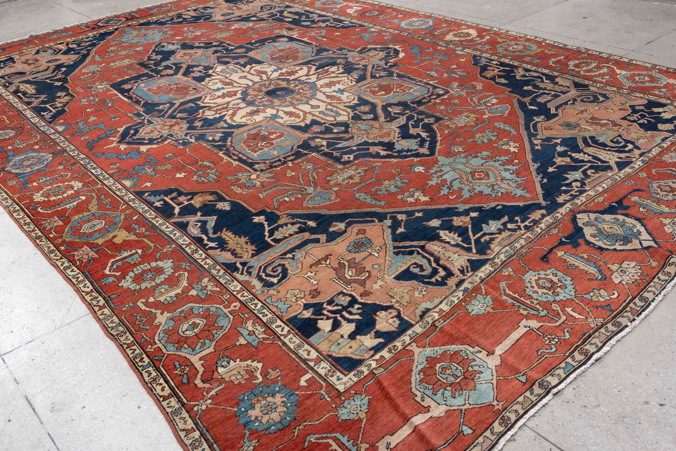 11' x 16' one-of-a-kind handmade antique Serapi oversize rug. Color palette: terracotta, navy, ivory, sky blue, camel, rose