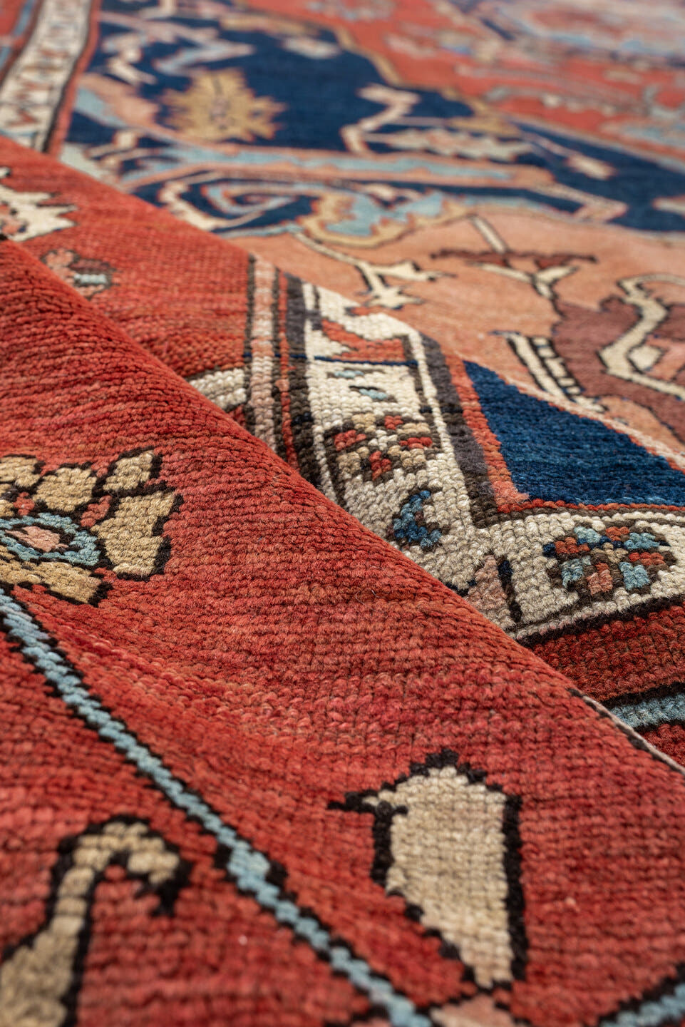 11' x 16' one-of-a-kind handmade antique Serapi oversize rug. Color palette: terracotta, navy, ivory, sky blue, camel, rose