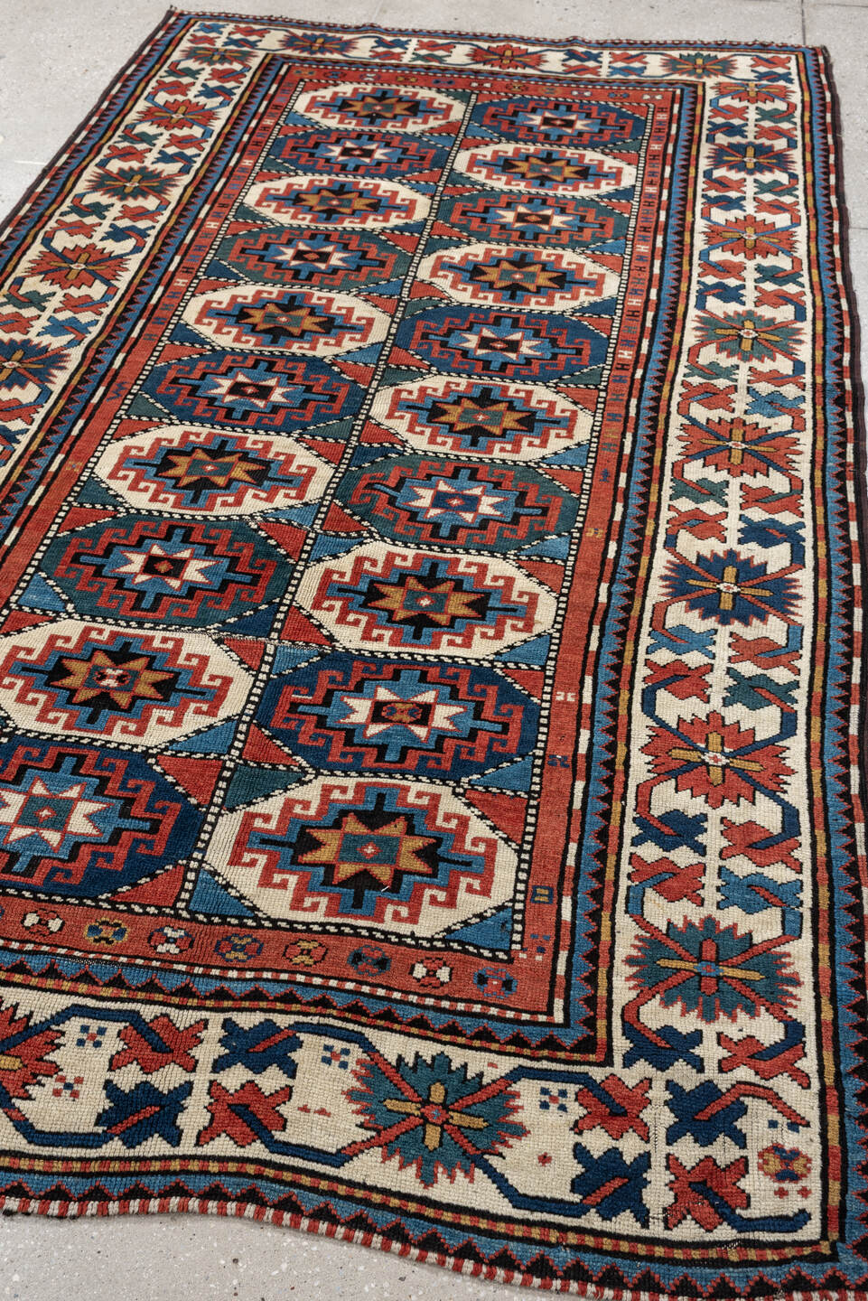 4' x 8' one-of-a-kind handmade vintage Kazak medium size rug. Color palette: teal, ivory, rust, navy, coral, charcoal, gold