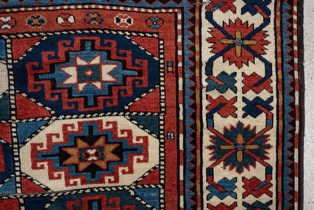 4' x 8' one-of-a-kind handmade vintage Kazak medium size rug. Color palette: teal, ivory, rust, navy, coral, charcoal, gold