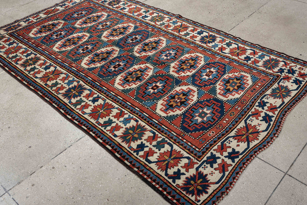 4' x 8' one-of-a-kind handmade vintage Kazak medium size rug. Color palette: teal, ivory, rust, navy, coral, charcoal, gold