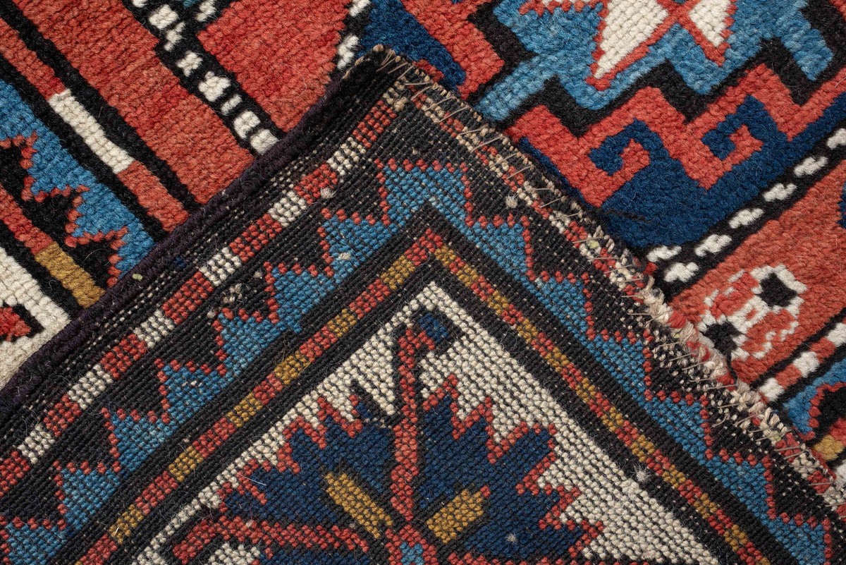 4' x 8' one-of-a-kind handmade vintage Kazak medium size rug. Color palette: teal, ivory, rust, navy, coral, charcoal, gold