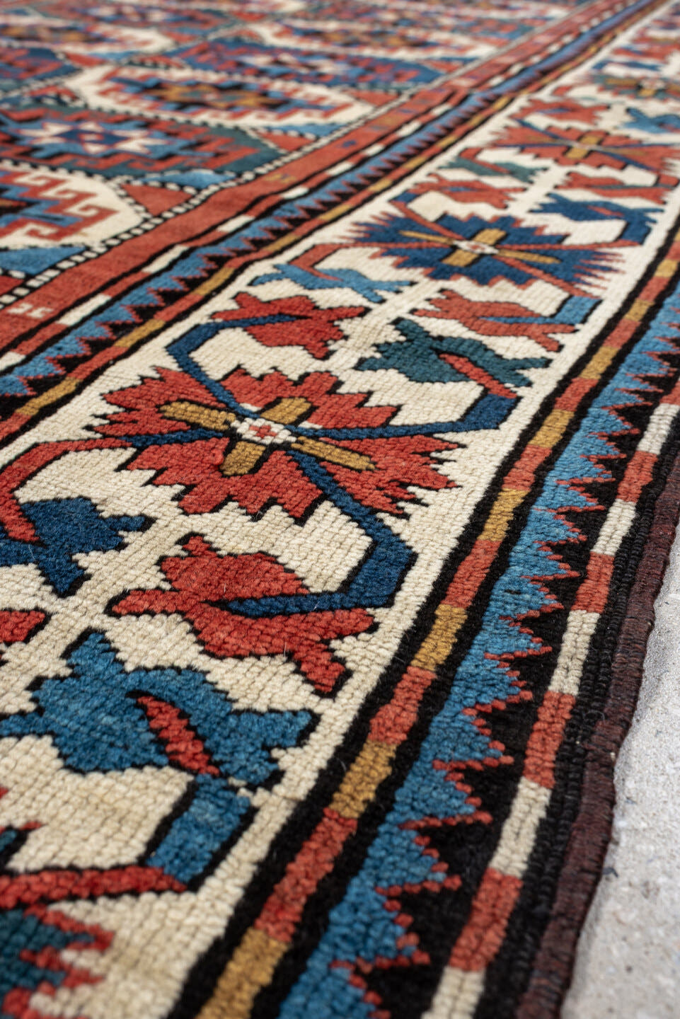 4' x 8' one-of-a-kind handmade vintage Kazak medium size rug. Color palette: teal, ivory, rust, navy, coral, charcoal, gold