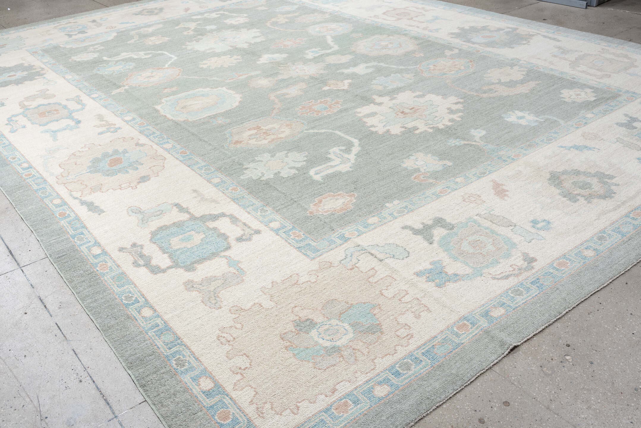 13' x 17' one-of-a-kind handmade vintage Oushak oversize rug. Color palette: pale blue, ivory, taupe, blush, cream, sky blue