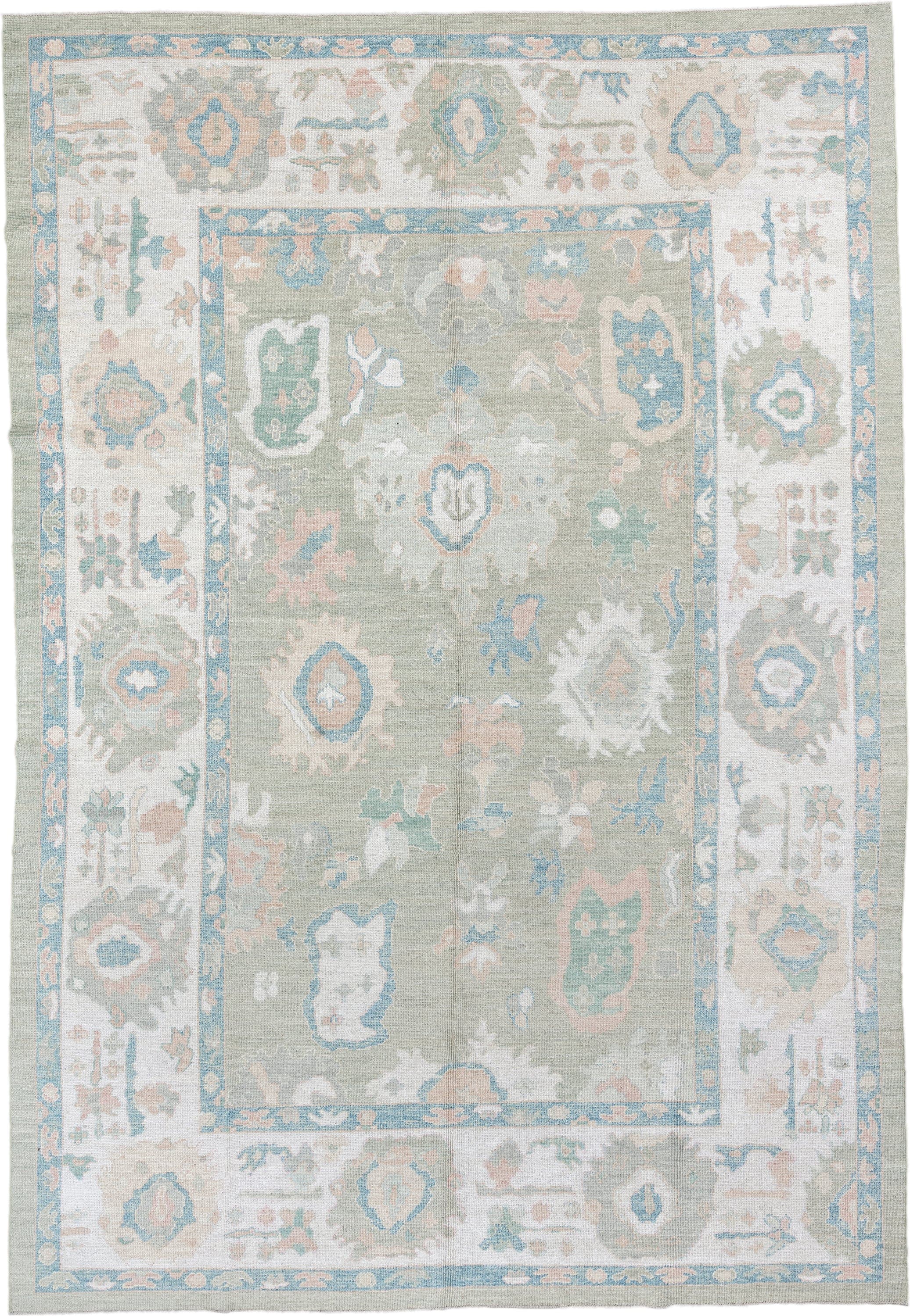 9' x 14' one-of-a-kind handmade vintage Oushak large size rug. Color palette: sage, ivory, sky blue, blush, taupe, cream
