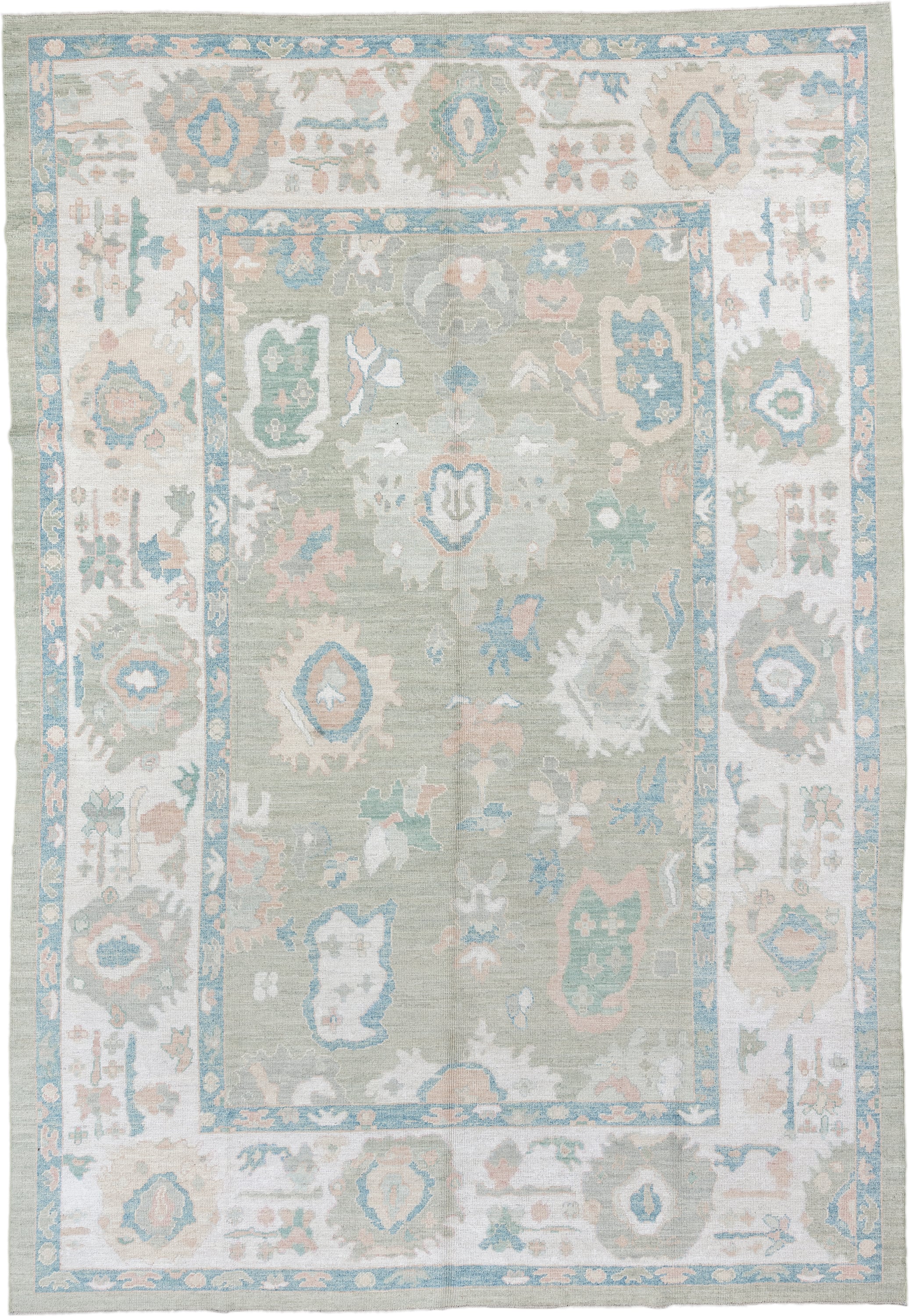 9' x 14' one-of-a-kind handmade vintage Oushak large size rug. Color palette: sage, ivory, sky blue, blush, taupe, cream