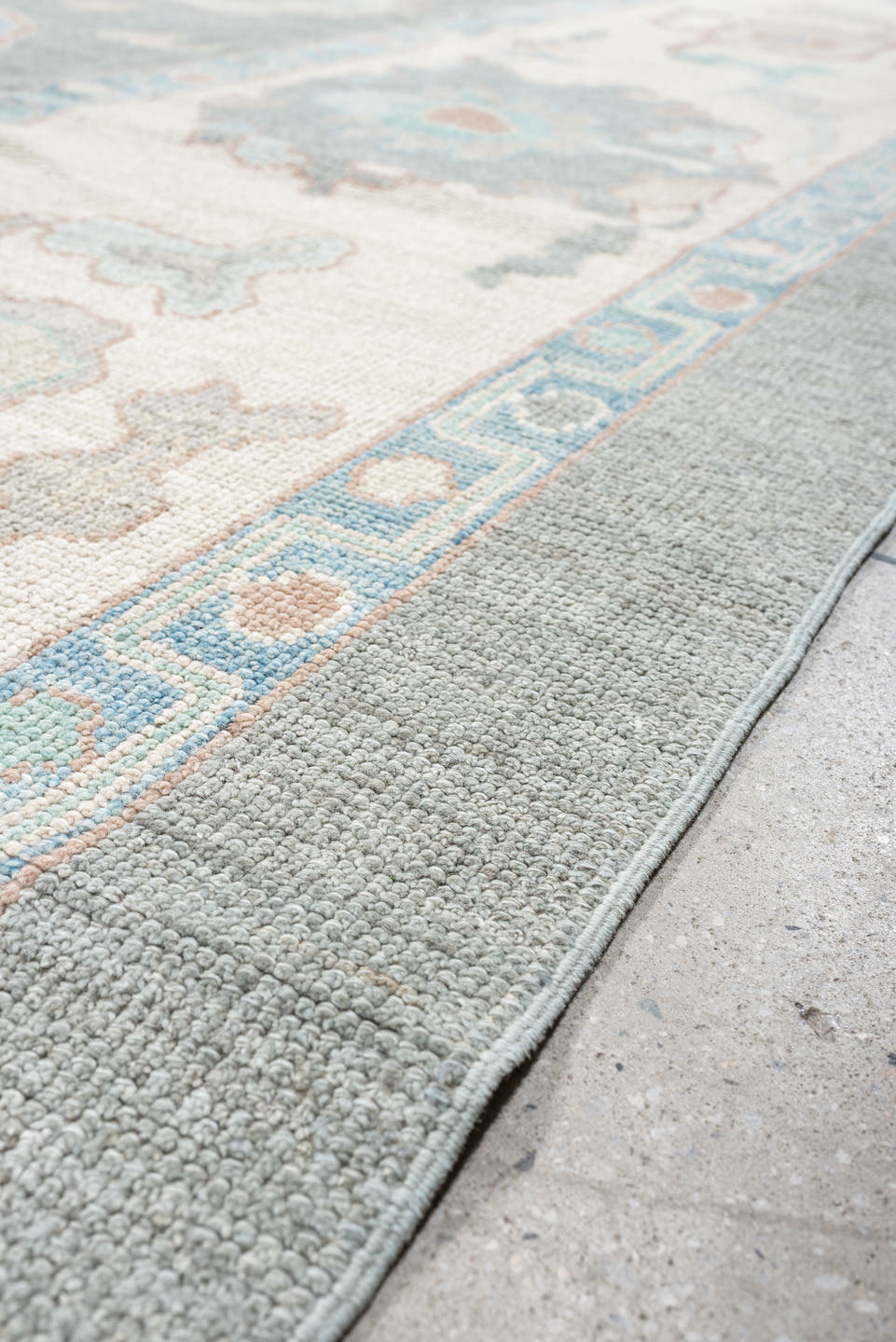 12' x 15' one-of-a-kind handmade vintage Oushak oversize rug. Color palette: pale blue, ivory, taupe, peach, sage, charcoal