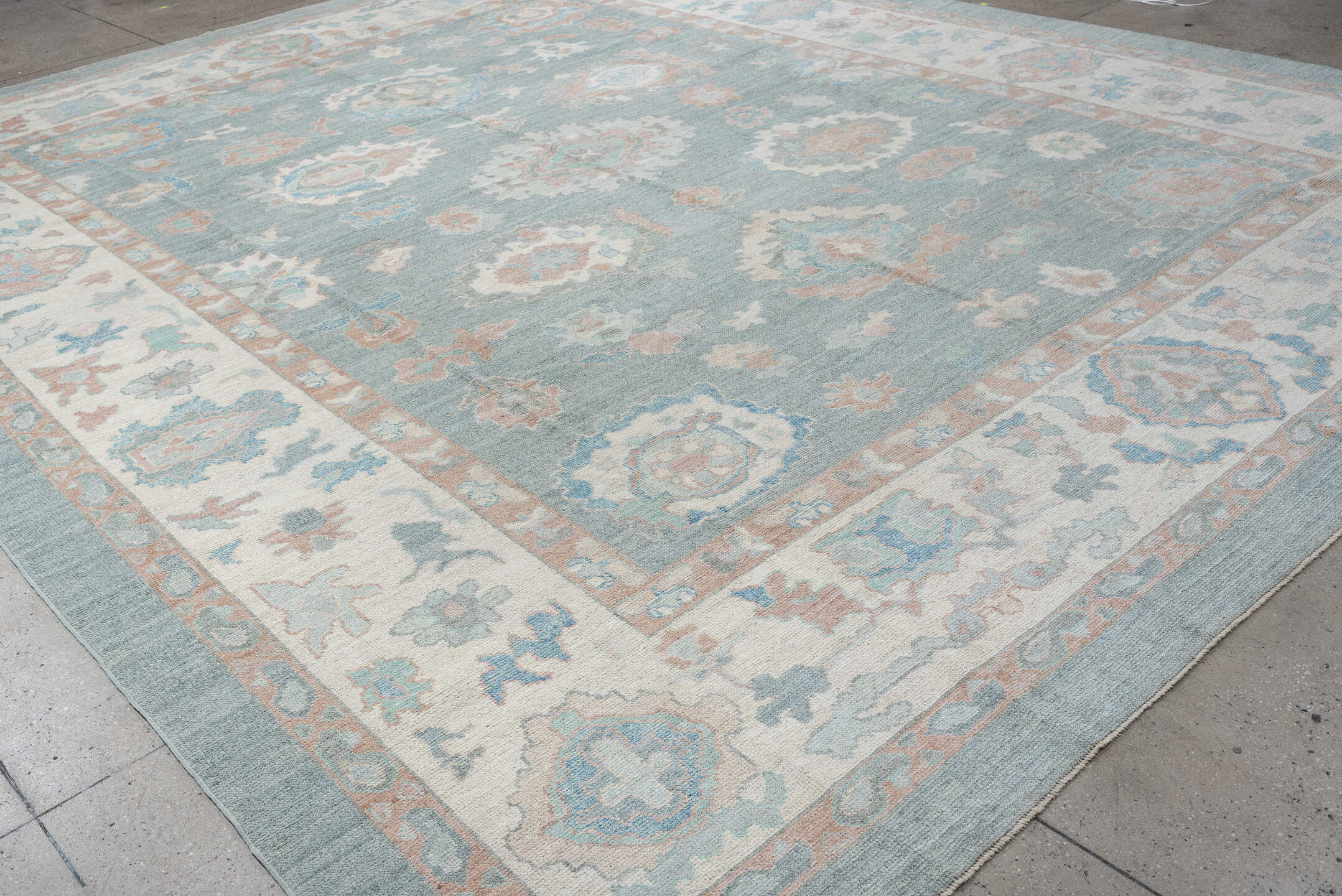 12' x 15' one-of-a-kind handmade vintage Oushak oversize rug. Color palette: sky blue, ivory, blush, pale blue, taupe, sage