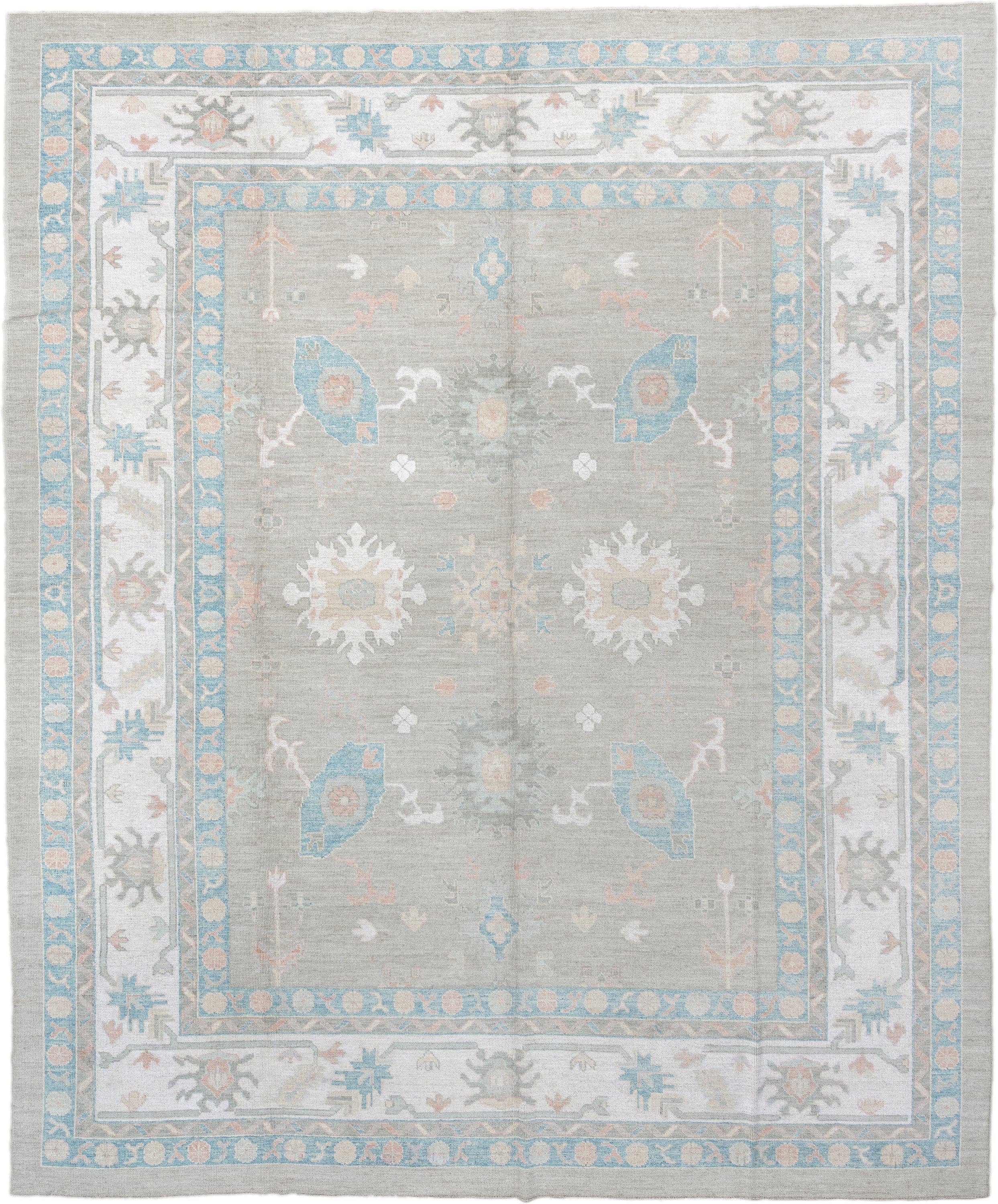 12' x 15' one-of-a-kind handmade vintage Oushak oversize rug. Color palette: pale gray, ivory, sky blue, peach, taupe, sage