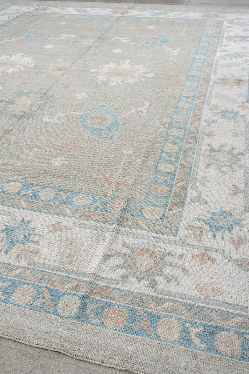 12' x 15' one-of-a-kind handmade vintage Oushak oversize rug. Color palette: pale gray, ivory, sky blue, peach, taupe, sage