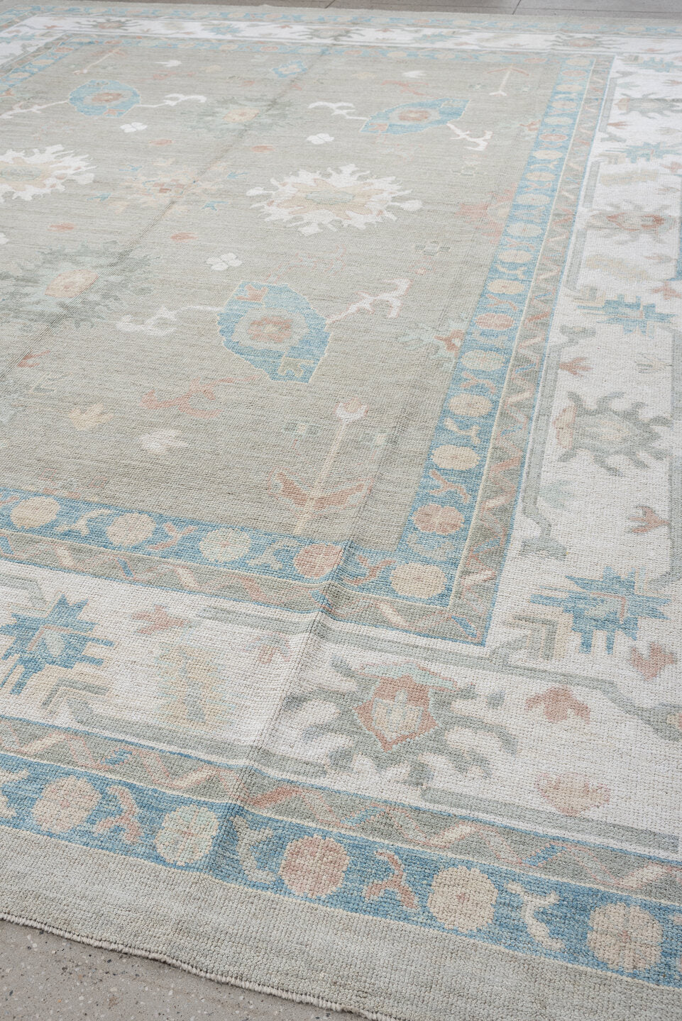 12' x 15' one-of-a-kind handmade vintage Oushak oversize rug. Color palette: pale gray, ivory, sky blue, peach, taupe, sage