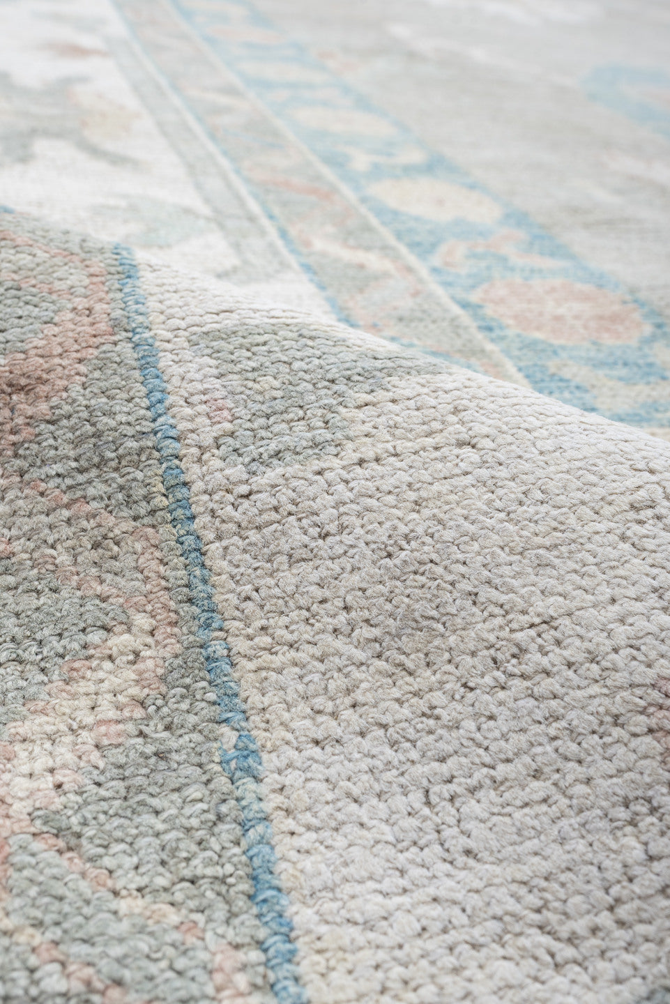 12' x 15' one-of-a-kind handmade vintage Oushak oversize rug. Color palette: pale gray, ivory, sky blue, peach, taupe, sage