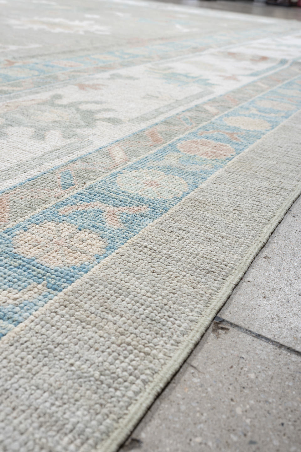 12' x 15' one-of-a-kind handmade vintage Oushak oversize rug. Color palette: pale gray, ivory, sky blue, peach, taupe, sage