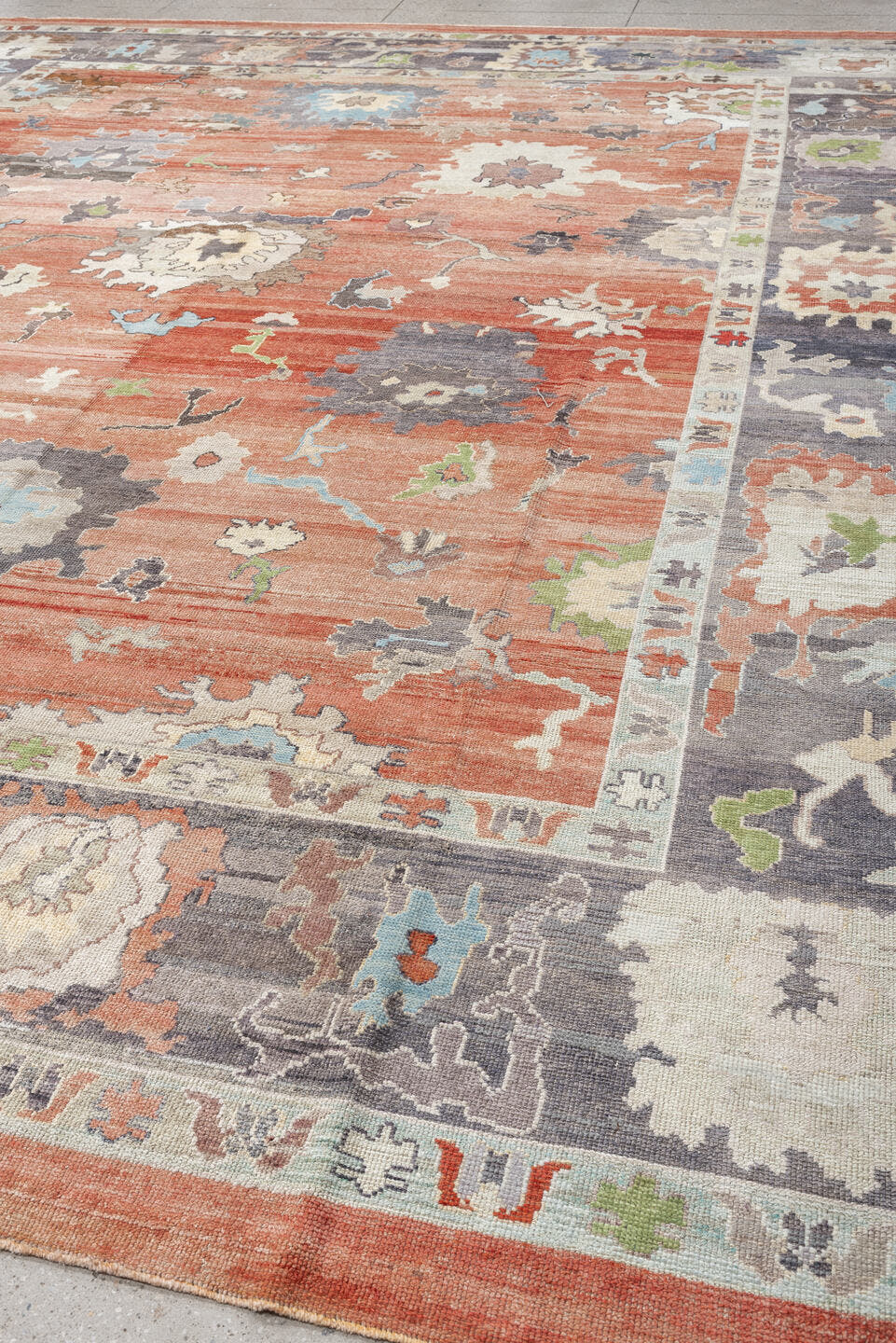 12' x 15' one-of-a-kind handmade vintage Oushak oversize rug. Color palette: coral, slate, ivory, sky blue, sage, taupe