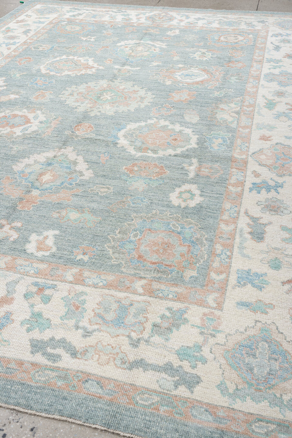 9' x 12' one-of-a-kind handmade vintage Oushak large size rug. Color palette: pale blue, ivory, blush, sage, peach, taupe