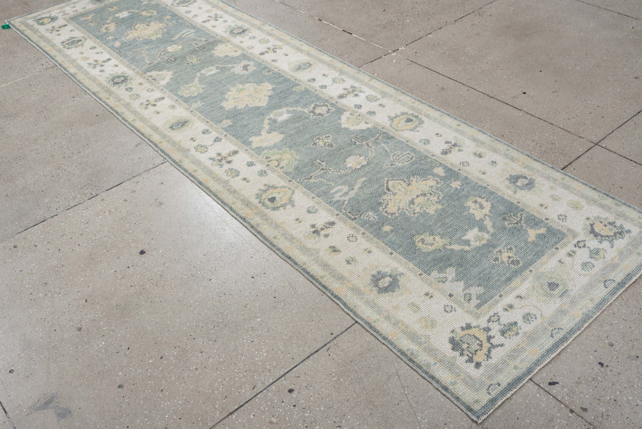 3' x 9' one-of-a-kind handmade vintage Oushak runner rug. Color palette: pale blue, ivory, sage, taupe, slate, cream