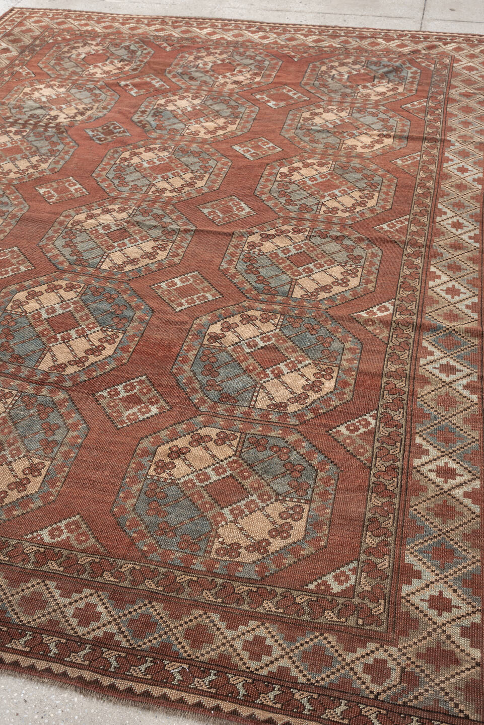 7' x 9' one-of-a-kind handmade vintage Afghan rug. Color palette: terracotta, ivory, blue gray, rust, taupe, camel, brown