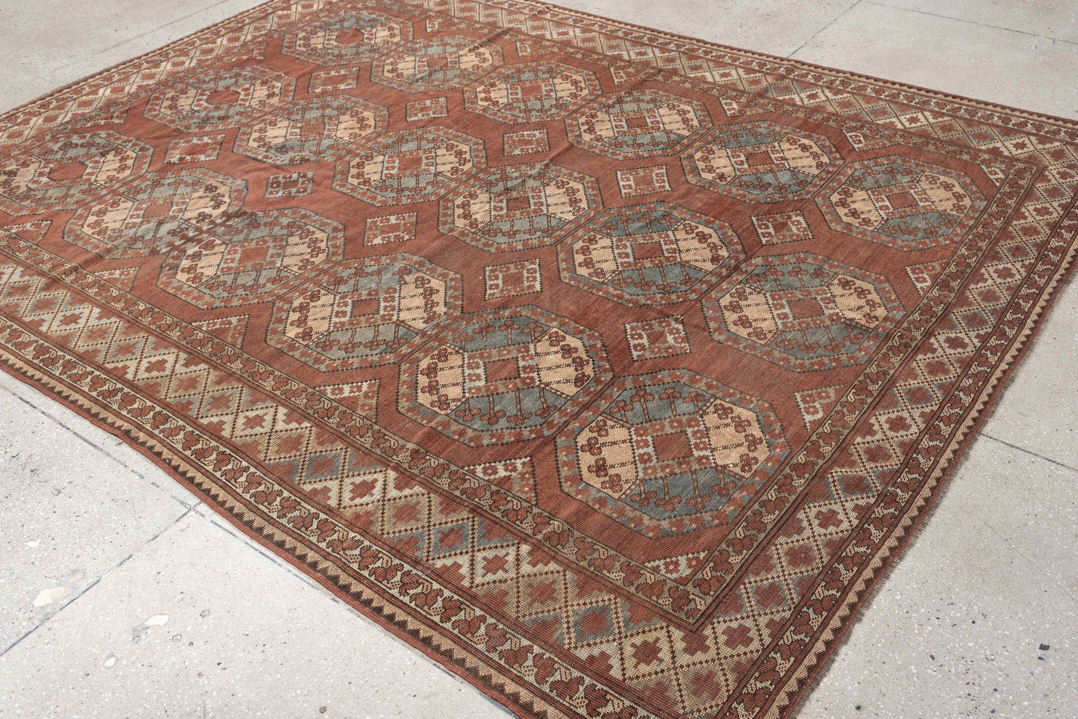 7' x 9' one-of-a-kind handmade vintage Afghan rug. Color palette: terracotta, ivory, blue gray, rust, taupe, camel, brown