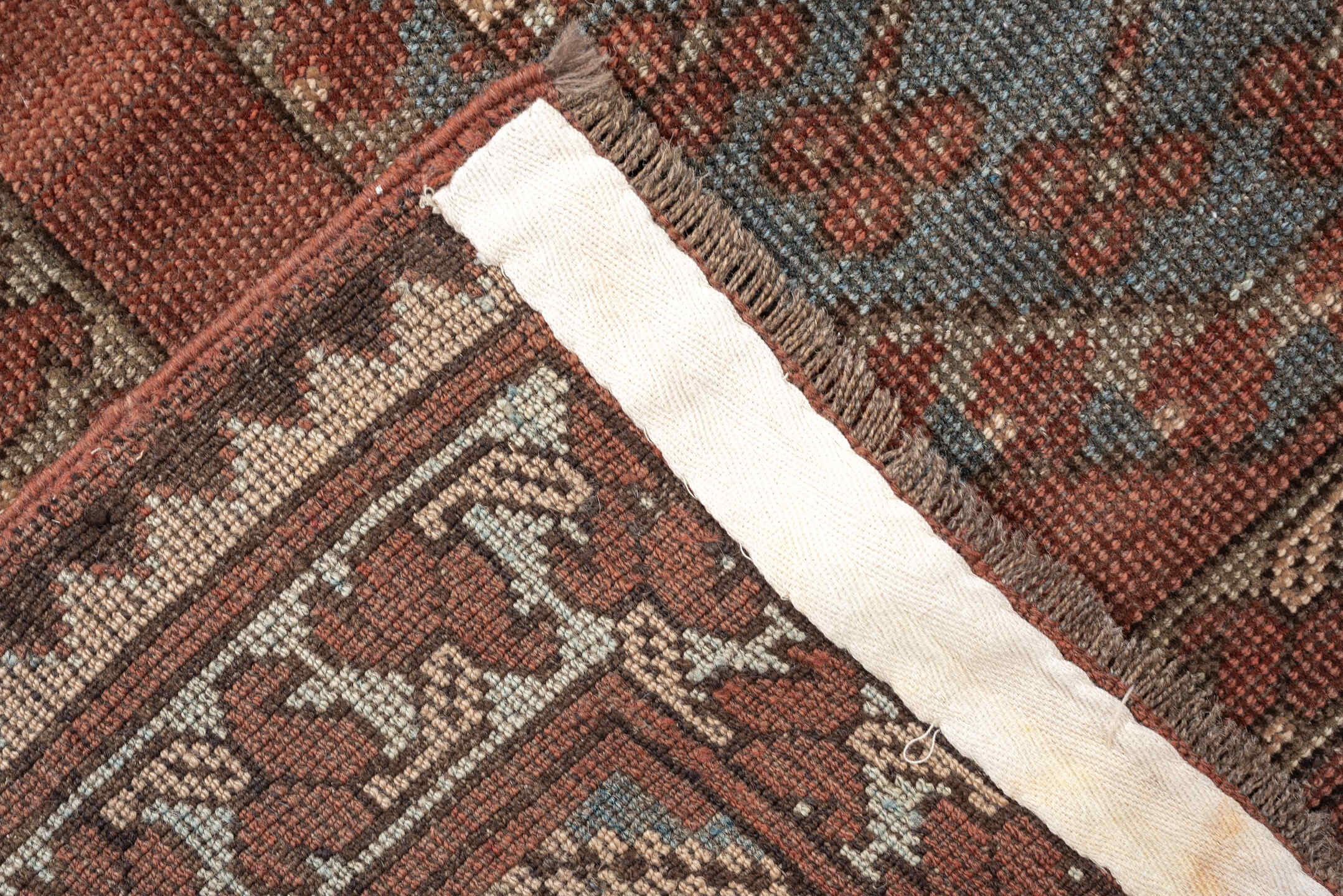7' x 9' one-of-a-kind handmade vintage Afghan rug. Color palette: terracotta, ivory, blue gray, rust, taupe, camel, brown